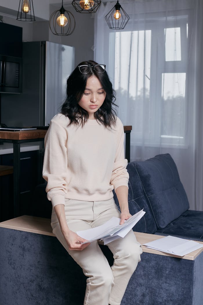 Problematic Young Woman holding Tax Papers