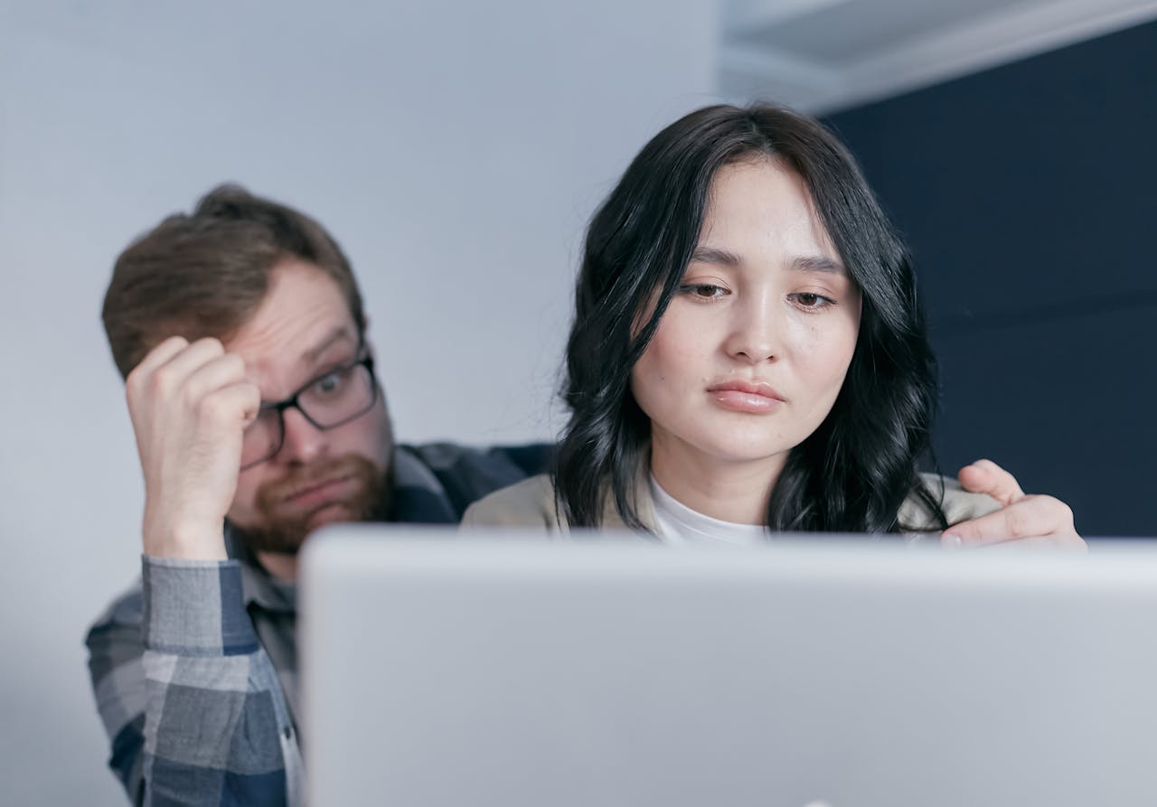 Man and Woman Looking at the Laptop